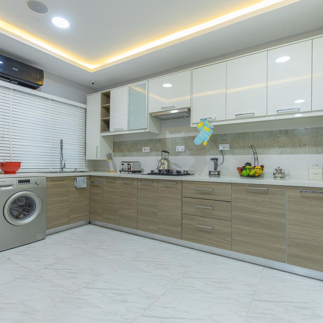 Furnished kitchen at Urban Prime Estate, Ajah, Lekki, with kitchen cabinets, washing machine heat extractor, gas burner and a fridge, currently selling with 18 months installment